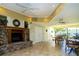 A welcoming clubhouse features a stone fireplace, tile flooring, and a bright dining area with large windows at 2621 Cove Cay Dr # 302, Clearwater, FL 33760