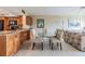 An open-concept living area with a glass dining table and adjacent kitchen at 2621 Cove Cay Dr # 302, Clearwater, FL 33760