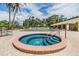 Relax in the warm, inviting hot tub with steps for easy access and lounge chairs by the main pool at 2621 Cove Cay Dr # 302, Clearwater, FL 33760