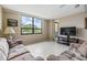 A cozy living room with a large window offering views of the greenery outside at 2621 Cove Cay Dr # 302, Clearwater, FL 33760