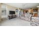 Bright living room featuring tile floors, a ceiling fan, and a view of the kitchen area at 2621 Cove Cay Dr # 302, Clearwater, FL 33760