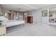 Spacious bedroom with tile flooring, ceiling fan, and view into the living room at 2621 Cove Cay Dr # 302, Clearwater, FL 33760