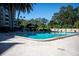 Community pool with lounge chairs surrounded by lush greenery at 2621 Cove Cay Dr # 302, Clearwater, FL 33760