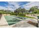 Enjoy outdoor games on the shuffleboard courts amidst lush greenery and clear blue skies at 2621 Cove Cay Dr # 302, Clearwater, FL 33760