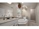 Spacious bathroom featuring double sinks, soaking tub, stand alone shower, and bright natural light at 2900 W Estrella St, Tampa, FL 33629