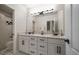 Well-lit bathroom featuring double sinks, granite counters, and modern fixtures at 2900 W Estrella St, Tampa, FL 33629