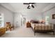 Bright bedroom features neutral decor, ceiling fan, and access to ensuite bathroom and walk-in closet at 2900 W Estrella St, Tampa, FL 33629