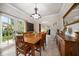 Traditional dining room with a large wooden table, chandelier, and french doors to the backyard at 2900 W Estrella St, Tampa, FL 33629