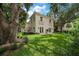 Elegant two-story home with manicured lawn, mature trees, and charming architectural details at 2900 W Estrella St, Tampa, FL 33629