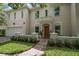 Charming two-story home showcasing a cozy front balcony, lush lawn, and a welcoming brick path to the front door at 2900 W Estrella St, Tampa, FL 33629