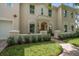 Stately two-story home featuring a charming front balcony, manicured lawn, and brick walkway leading to the front entrance at 2900 W Estrella St, Tampa, FL 33629
