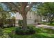 Elegant two-story home with a well-manicured lawn, brick driveway, attached garage, and mature shade tree at 2900 W Estrella St, Tampa, FL 33629