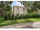 Elegant home exterior featuring a lush green lawn and mature trees providing shade and curb appeal at 2900 W Estrella St, Tampa, FL 33629