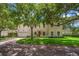 Elegant home exterior featuring a lush green lawn and mature trees providing shade and curb appeal at 2900 W Estrella St, Tampa, FL 33629