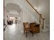 Foyer featuring tile floors, staircase with white banister, and decorative chair at 2900 W Estrella St, Tampa, FL 33629
