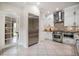 Bright kitchen with stainless steel appliances, white cabinets, decorative tile backsplash, and an adjacent dining area at 2900 W Estrella St, Tampa, FL 33629