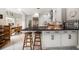 Modern kitchen with black countertops, white cabinets, and barstool seating at the island at 2900 W Estrella St, Tampa, FL 33629