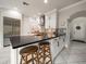 Kitchen featuring white cabinets, stainless appliances, tile backsplash, and island with breakfast bar at 2900 W Estrella St, Tampa, FL 33629