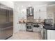 Gourmet kitchen featuring stainless steel appliances, white cabinets, and decorative backsplash at 2900 W Estrella St, Tampa, FL 33629