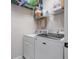 Bright laundry room featuring a modern washer, dryer, and ample shelving for storage at 2900 W Estrella St, Tampa, FL 33629