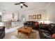 Open concept living room with white cabinets, tile floors, leather furniture, and ceiling fan at 2900 W Estrella St, Tampa, FL 33629