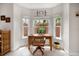 Bright home office with a wooden desk, natural light from three windows, and tile flooring at 2900 W Estrella St, Tampa, FL 33629