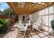 Inviting outdoor patio featuring brick pavers, pergola, and comfortable seating for relaxing and entertaining at 2900 W Estrella St, Tampa, FL 33629