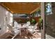 Outdoor patio featuring brick pavers, white seating set, and wooden pergola at 2900 W Estrella St, Tampa, FL 33629