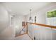 Stairway with white railing, chandelier, and natural light from the windows at 2900 W Estrella St, Tampa, FL 33629