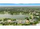 A panoramic aerial view of a neighborhood, lake and surrounding landscape at 3101 Beaver Pond Trl, Valrico, FL 33596