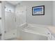 Bright bathroom with a soaking tub, a separate glass-enclosed shower, and modern fixtures at 3101 Beaver Pond Trl, Valrico, FL 33596