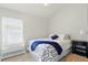 Bright bedroom featuring neutral walls, carpet flooring, and a window with blinds at 3101 Beaver Pond Trl, Valrico, FL 33596