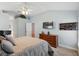 Inviting bedroom featuring a comfortable bed, a dresser with a TV, and a lofted decorative space at 3101 Beaver Pond Trl, Valrico, FL 33596