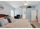 Cozy bedroom with a glimpse into an ensuite bathroom, a comfortable bed, and a functional workspace at 3101 Beaver Pond Trl, Valrico, FL 33596