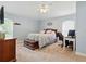 Serene bedroom with light blue walls, a comfortable bed, and a functional workspace with a computer desk at 3101 Beaver Pond Trl, Valrico, FL 33596