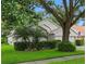 Beautifully landscaped home with a lush lawn, decorative shrubbery and a mature tree at 3101 Beaver Pond Trl, Valrico, FL 33596