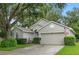 Attractive home with a lush lawn, manicured bushes, and a two-car garage at 3101 Beaver Pond Trl, Valrico, FL 33596