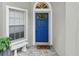 Inviting front entrance featuring a vibrant blue door, decorative wreath and neutral tile at 3101 Beaver Pond Trl, Valrico, FL 33596