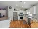 Updated kitchen boasts white cabinetry, granite counters, stainless appliances and hardwood floors at 3101 Beaver Pond Trl, Valrico, FL 33596