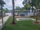 Charming backyard featuring a patio, mini-golf, and artificial turf, ideal for outdoor entertaining and leisure at 318 W Crest Ave, Tampa, FL 33603