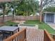 Enjoy the outdoor living space with a wooden deck, putting green, shed, and fire pit at 318 W Crest Ave, Tampa, FL 33603