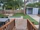 Enjoy the outdoor living space with a wooden deck, putting green, shed, and fire pit at 318 W Crest Ave, Tampa, FL 33603