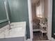 Stylish bathroom features quartz countertop vanity and doorway view into bedroom at 318 W Crest Ave, Tampa, FL 33603