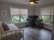 Bright bedroom with wood floor, desk setup, and ample natural light at 318 W Crest Ave, Tampa, FL 33603