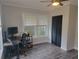 Bright bedroom with wood floor, desk setup, and ample natural light at 318 W Crest Ave, Tampa, FL 33603