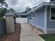 Exterior view showing the side of the home with a shed and fenced-in yard, providing storage and privacy at 318 W Crest Ave, Tampa, FL 33603