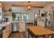 Open kitchen and living area with white cabinets, island, and stainless steel appliances at 318 W Crest Ave, Tampa, FL 33603