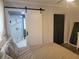 Bedroom with sliding door to the bathroom featuring a glass shower and hexagon tile at 318 W Crest Ave, Tampa, FL 33603