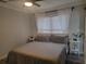 Bedroom with neutral tones, sheer curtains, and simple furnishings at 318 W Crest Ave, Tampa, FL 33603