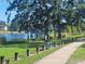 Scenic park with a lakeside walking path, featuring lush grass and mature trees, perfect for recreation at 318 W Crest Ave, Tampa, FL 33603